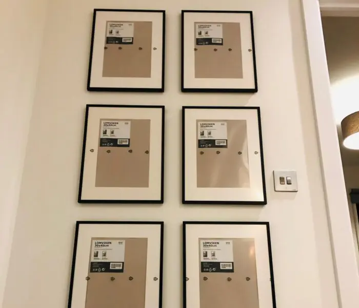 Large heavy ornate oil painting safely anchored to a wall by a Finchley handyman specialist